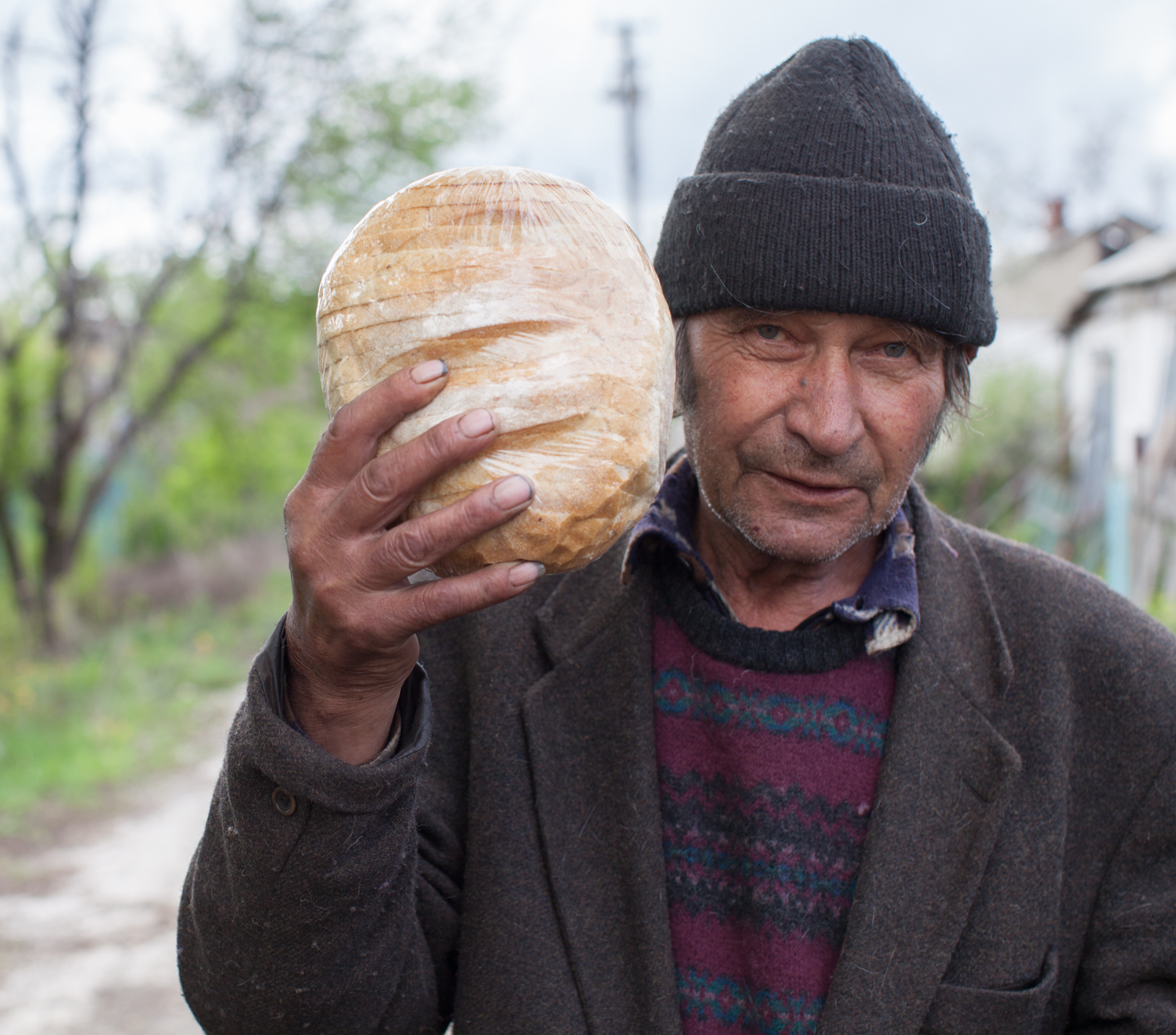 Refugee man from eastern Ukraine holding a loaf of bread