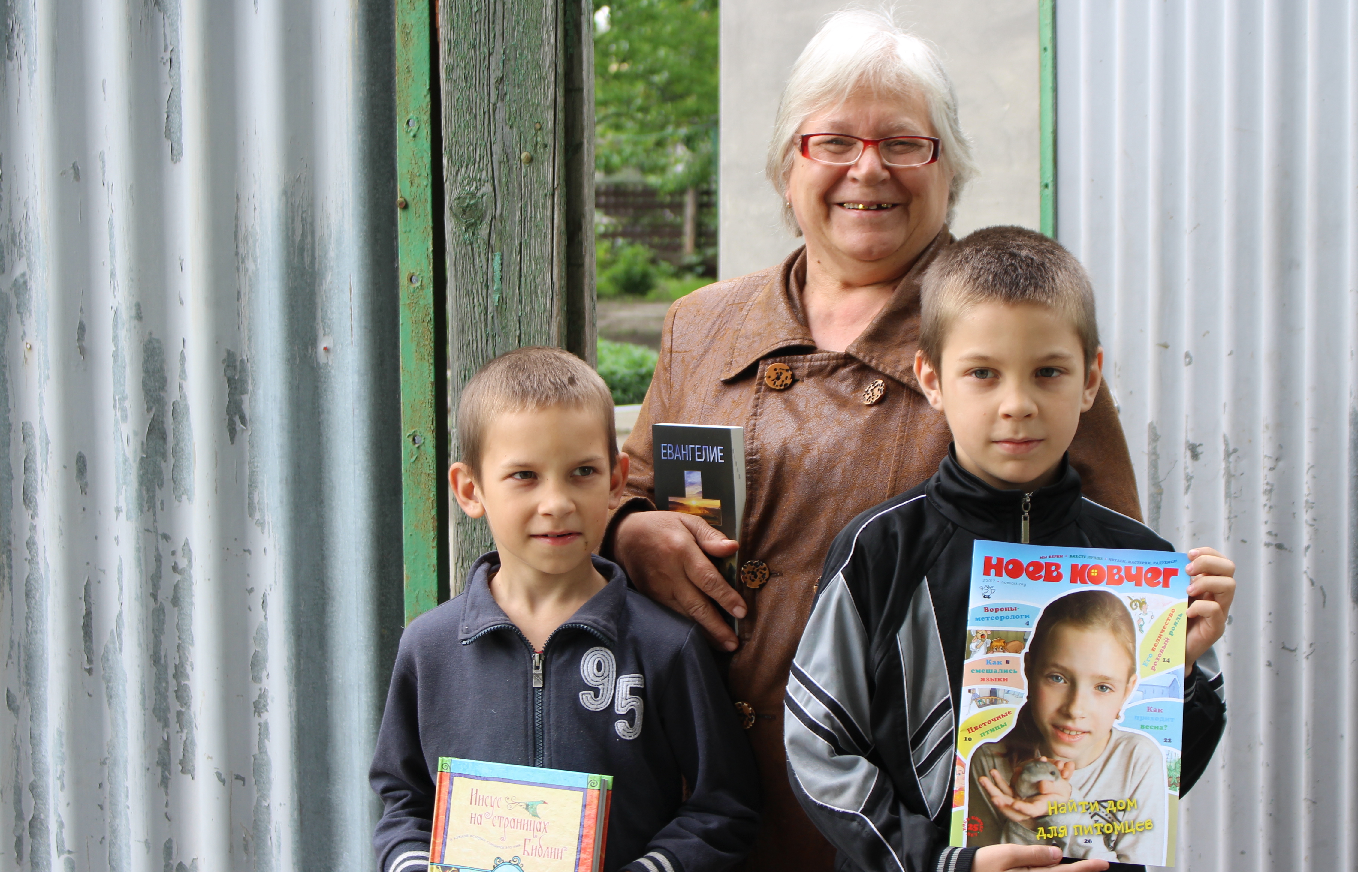 Grandma and grandsons holding Scripture pieces