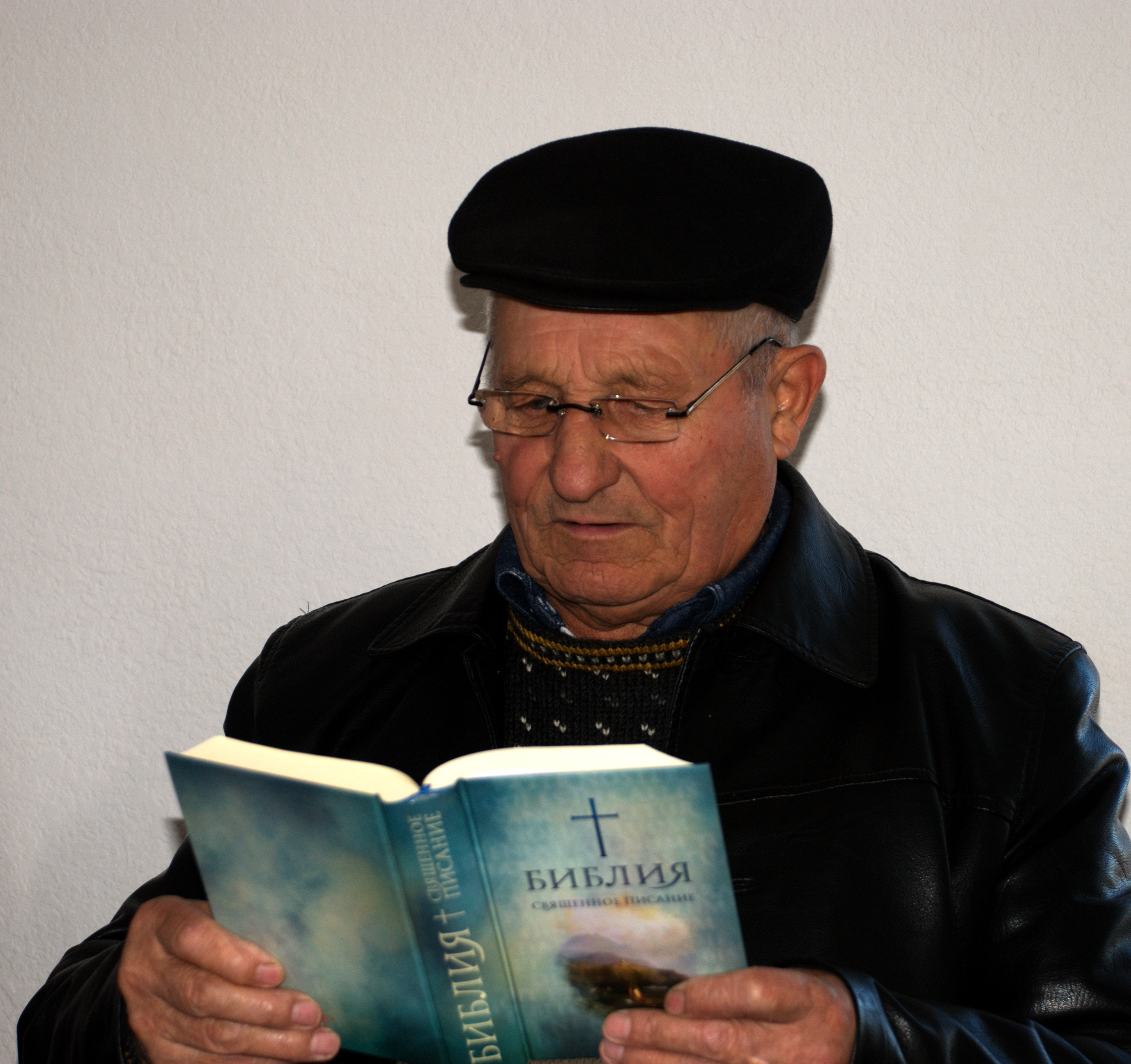 Ukrainian man with eyeglasses reading Scripture