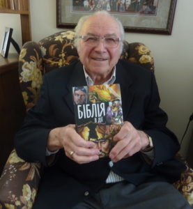 Bill Kapataniuk with a copy of the Action Bible in the Ukrainian language 