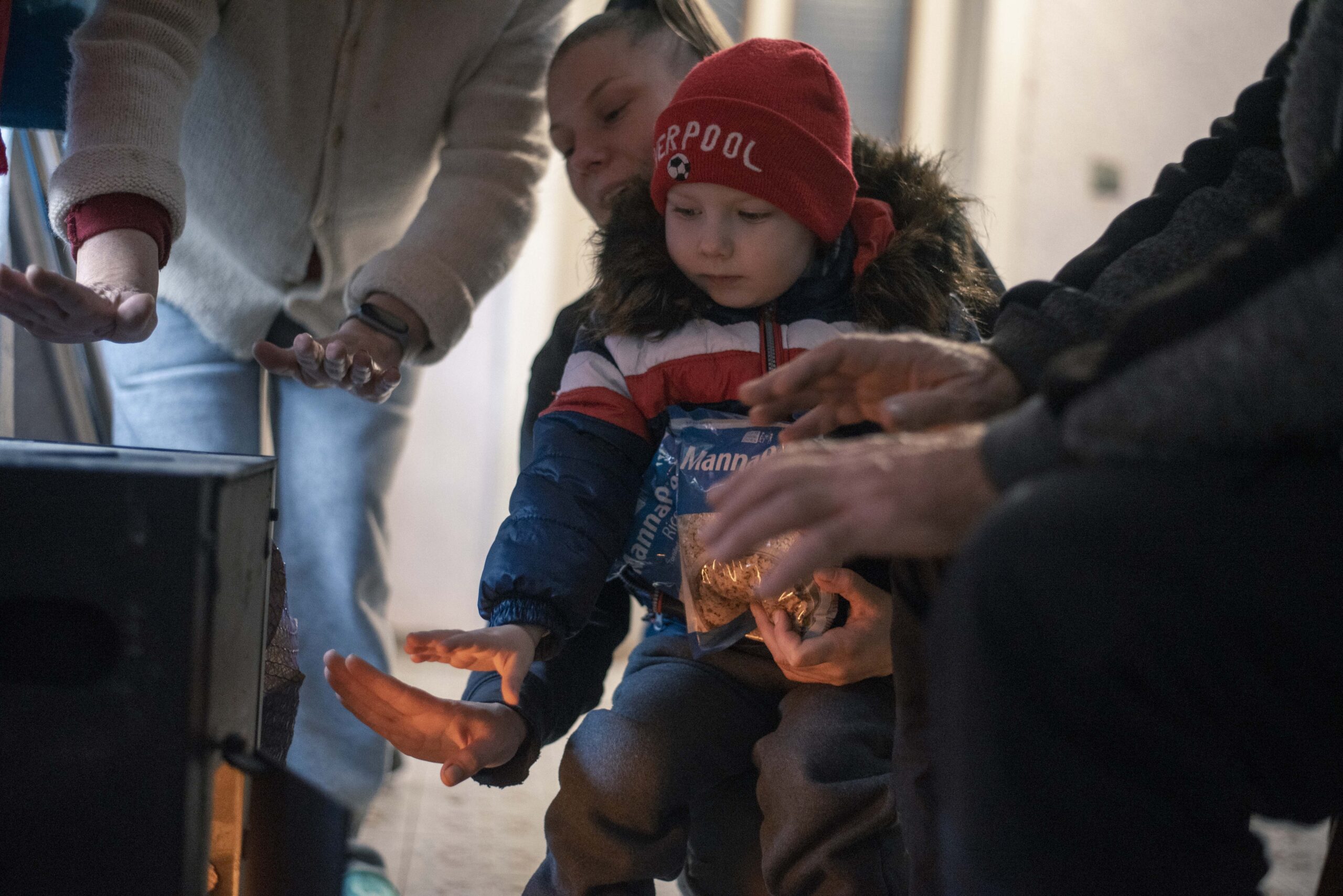 Child getting warm near wood burning stove