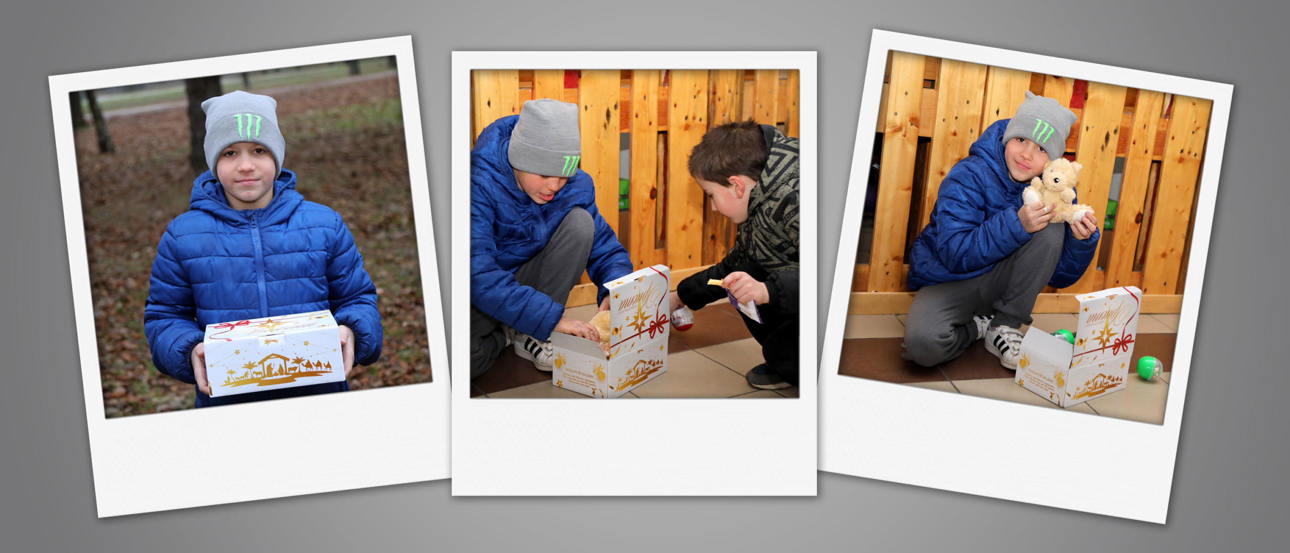 Two Ukrainian boys crouched on a tiled floor, opening and enjoying small treats next to their decorated Gift of Hope boxes.
