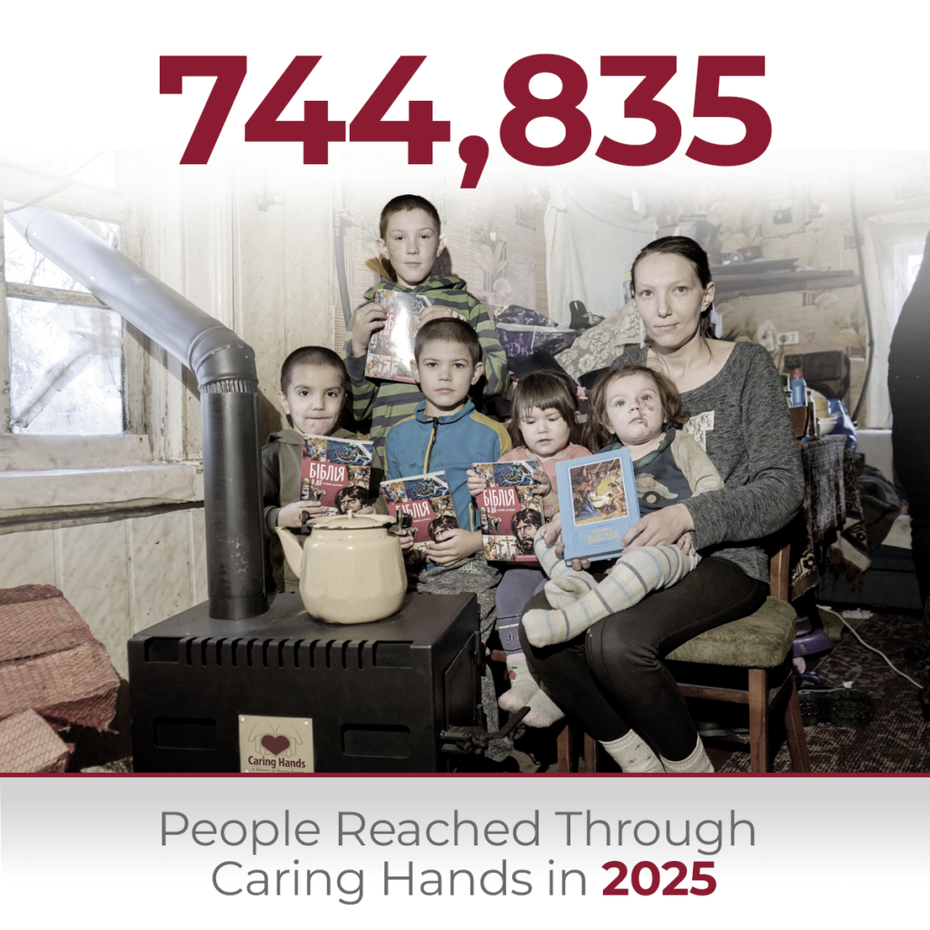 Infographic showing 744,835 people reached through Caring Hands in 2025, featuring a mother and four children sitting inside a home near a wood-burning stove while holding books.